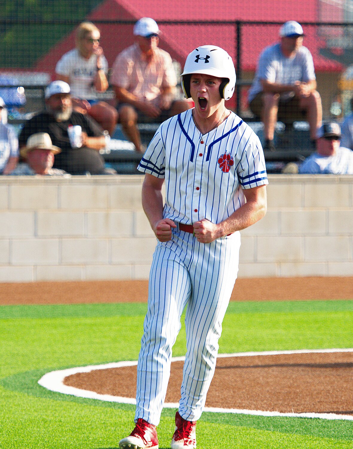 Glen Hartley celebrates scoring the first run of the game after getting on with a lead-off triple. [buy panther baseball pictures]